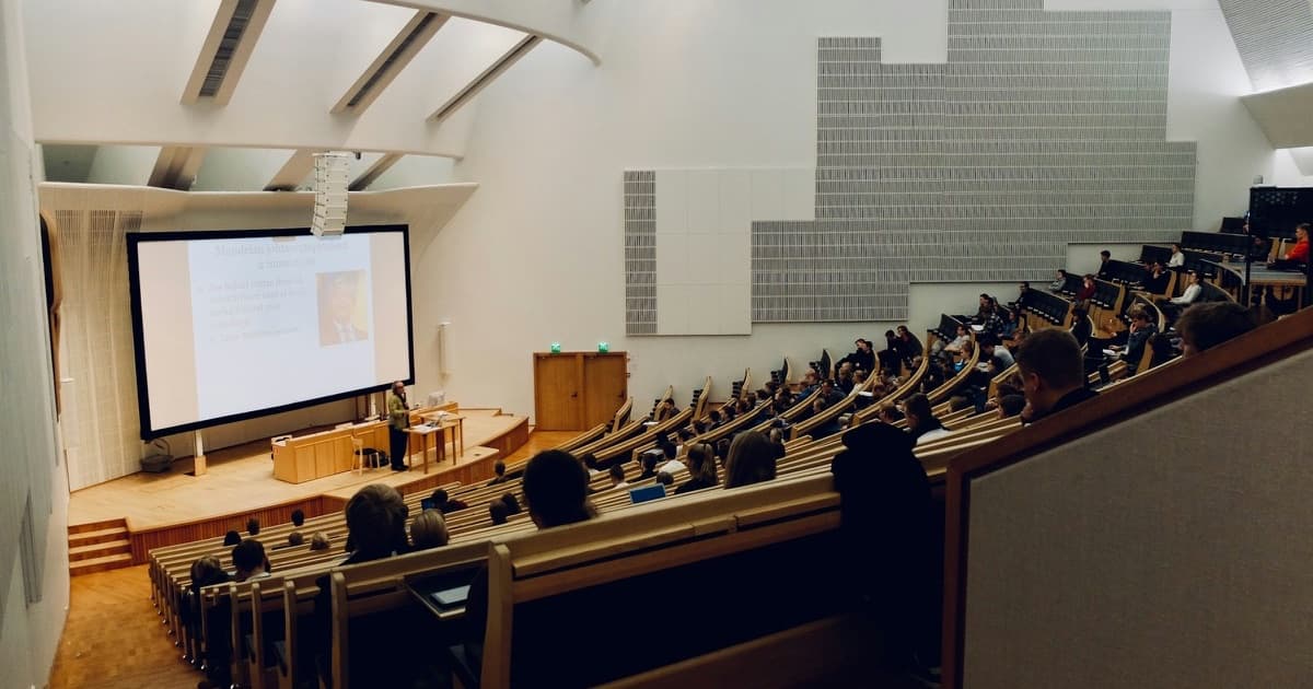 A lecture theatre with students seated in rows facing the front